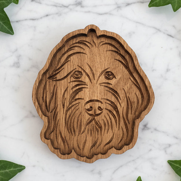 A wooden tray with a carved design of a Golden Doodle dog&