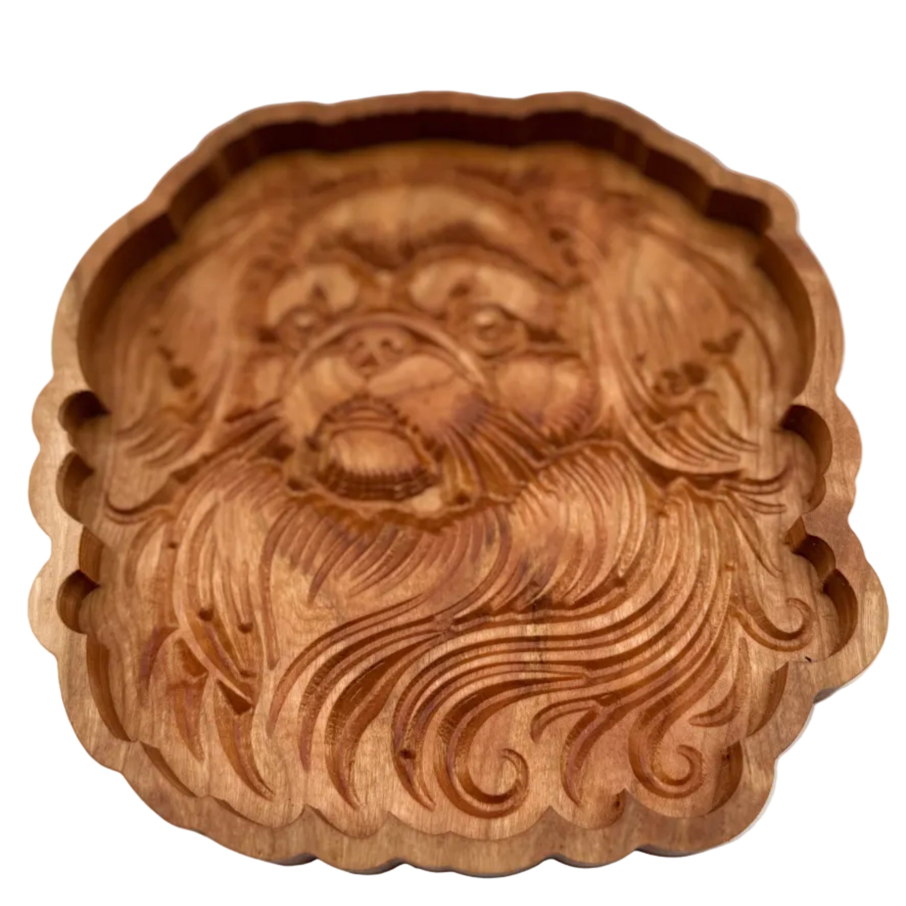 A round, hand-carved wooden decorative piece featuring a stylized face with flowing hair, shown against a plain light gray background.