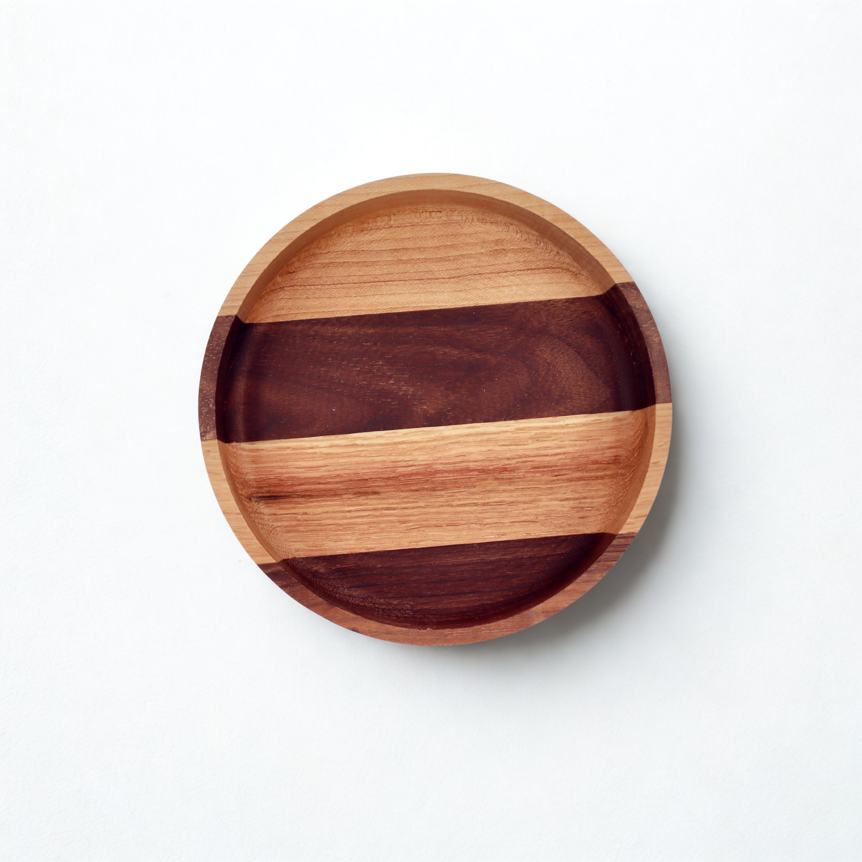 Wooden plate with striped design on a white background
