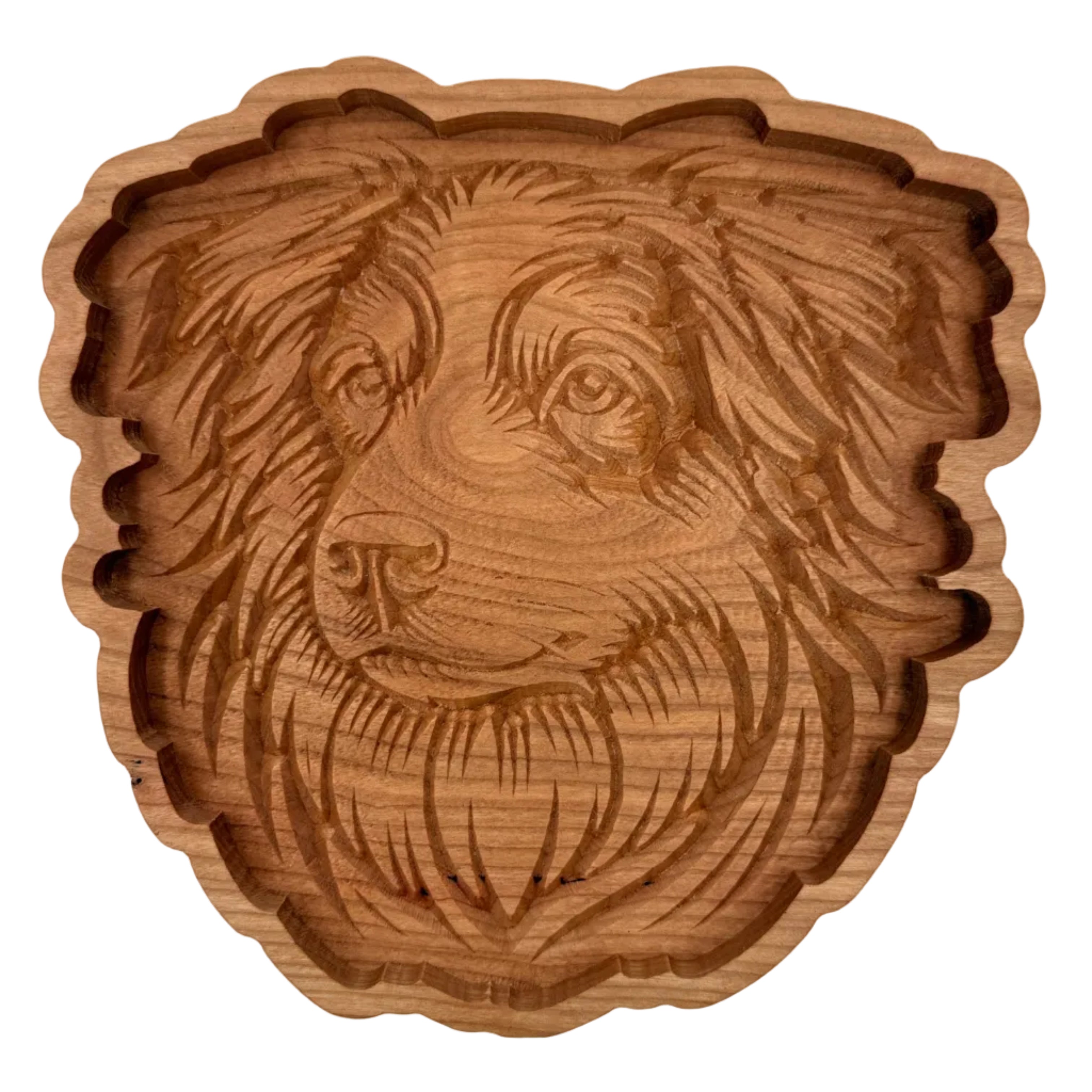 A hand-carved wooden dog head tray or bowl with detailed wood grain and a scalloped edge, shown on a plain white background.