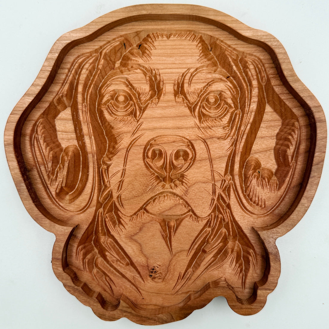 A scalloped wooden serving tray carved with a detailed dog portrait, shown on a plain white background.