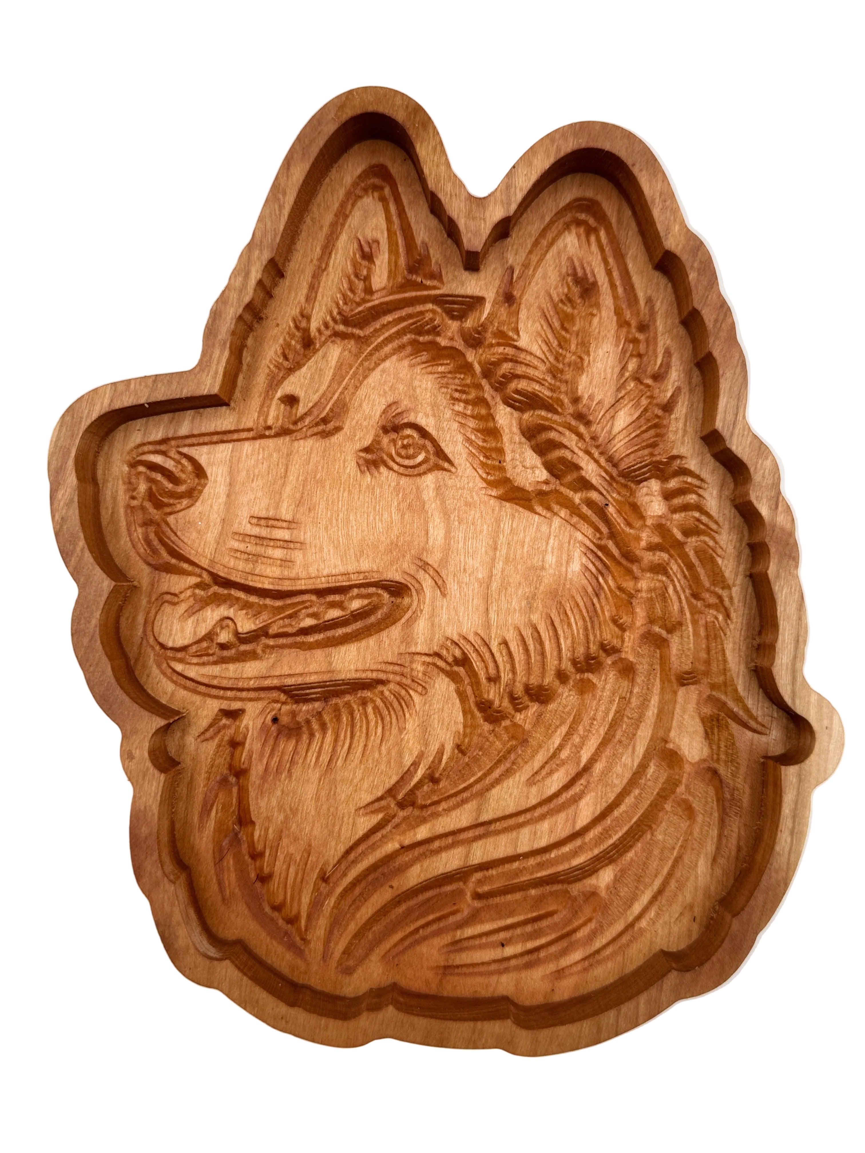 A carved wooden plaque or tray shaped like a dog&