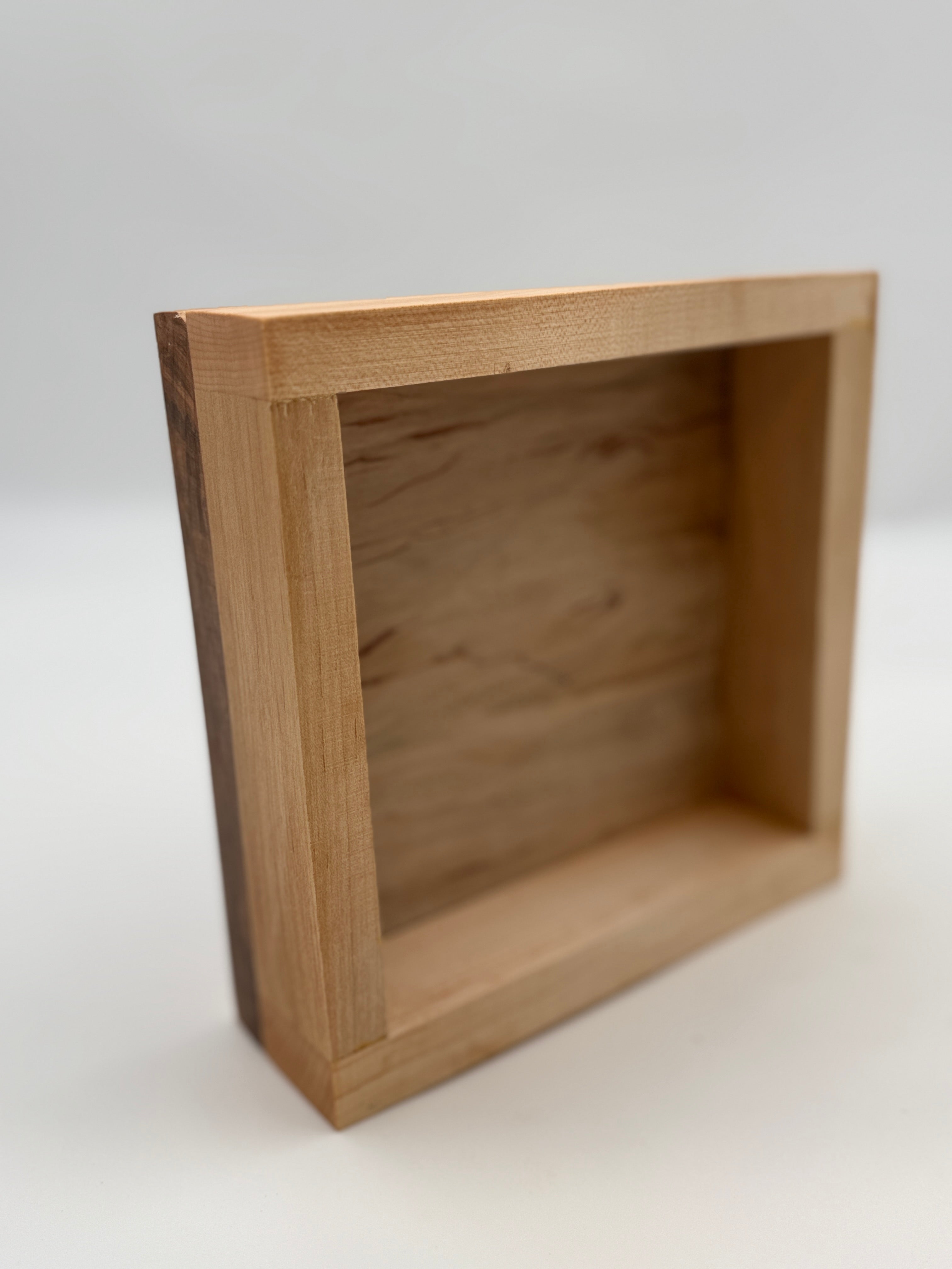 Wooden box with a lid on a white background