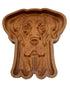 A carved wooden dog-shaped tray or dish with a warm medium-brown wood finish, photographed from above on a plain white background.