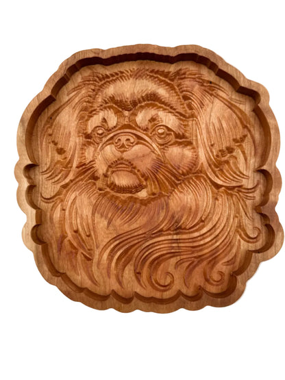 A round, scalloped-edge wooden serving tray featuring an intricately carved lion face and mane in warm medium brown wood, shown against a plain white background.