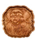 A round, scalloped-edge wooden serving tray featuring an intricately carved lion face and mane in warm medium brown wood, shown against a plain white background.