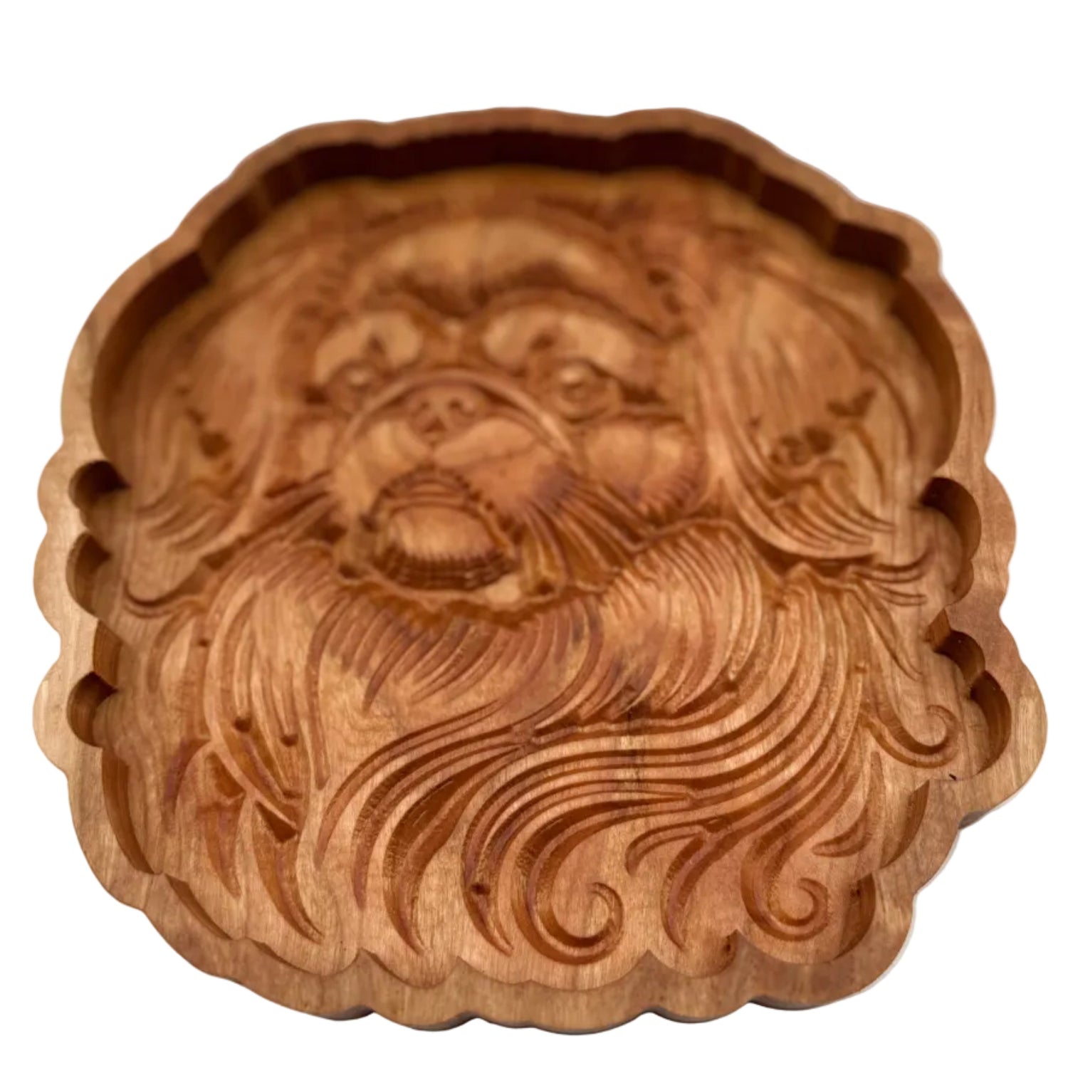 A round, hand-carved wooden decorative piece featuring a stylized face with flowing hair, shown against a plain light gray background.