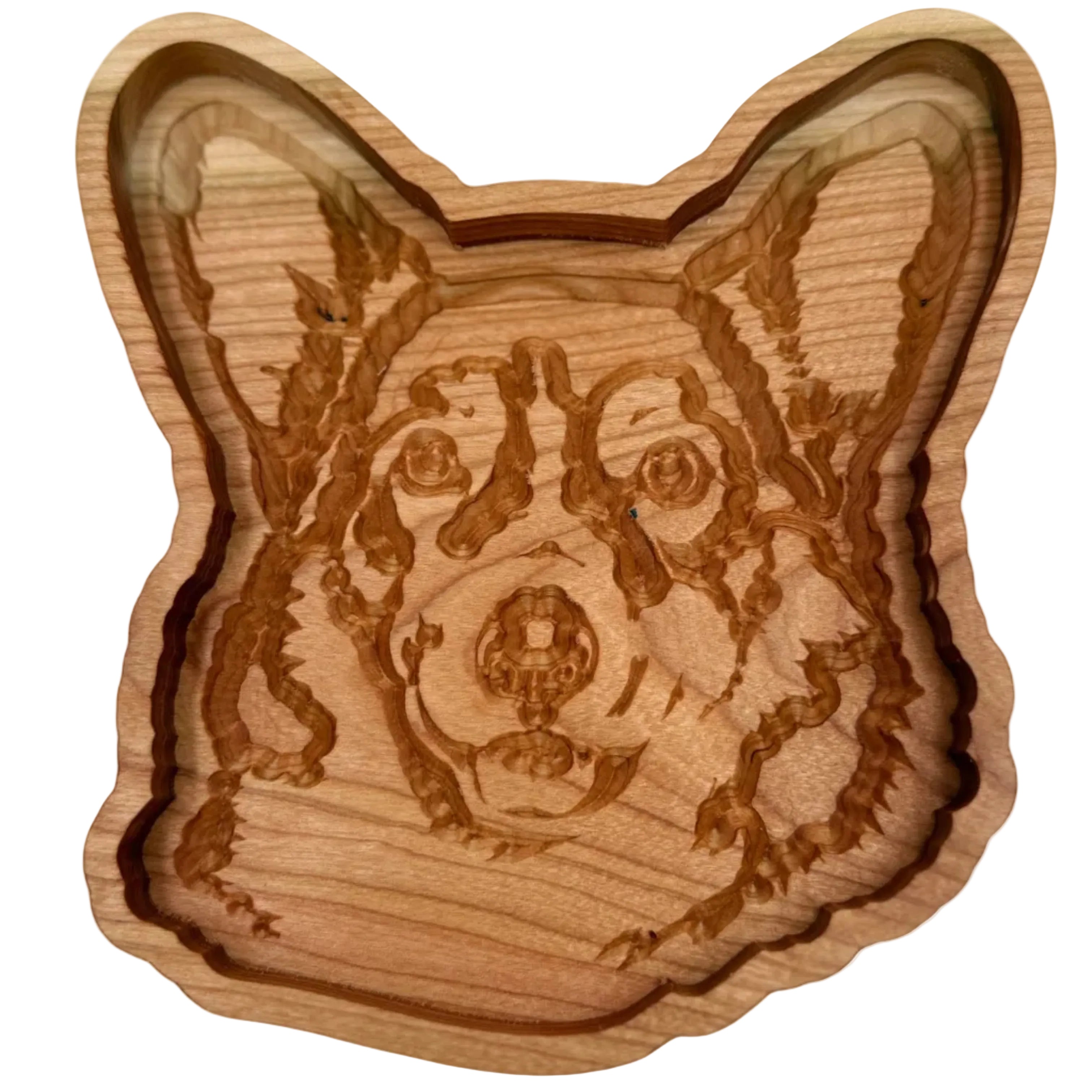 A carved wooden dog head tray or dish with detailed engravings of a dog&