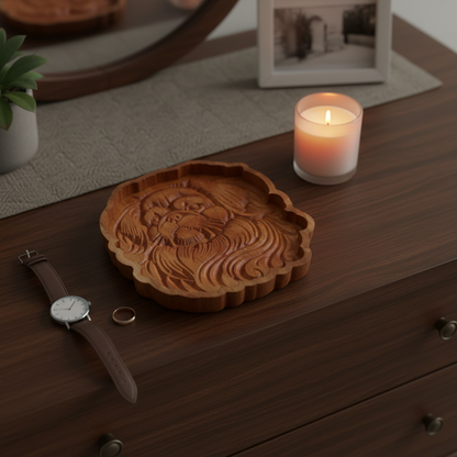 Pekingese cherry wood catch-all tray on a bedroom dresser with a watch, ring, and candle, shot from above