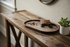 Black walnut blue resin oval tray on an entryway console with keys, wallet and sunglasses