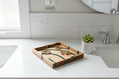 Maple green resin tray on a bathroom vanity with jewelry and succulent